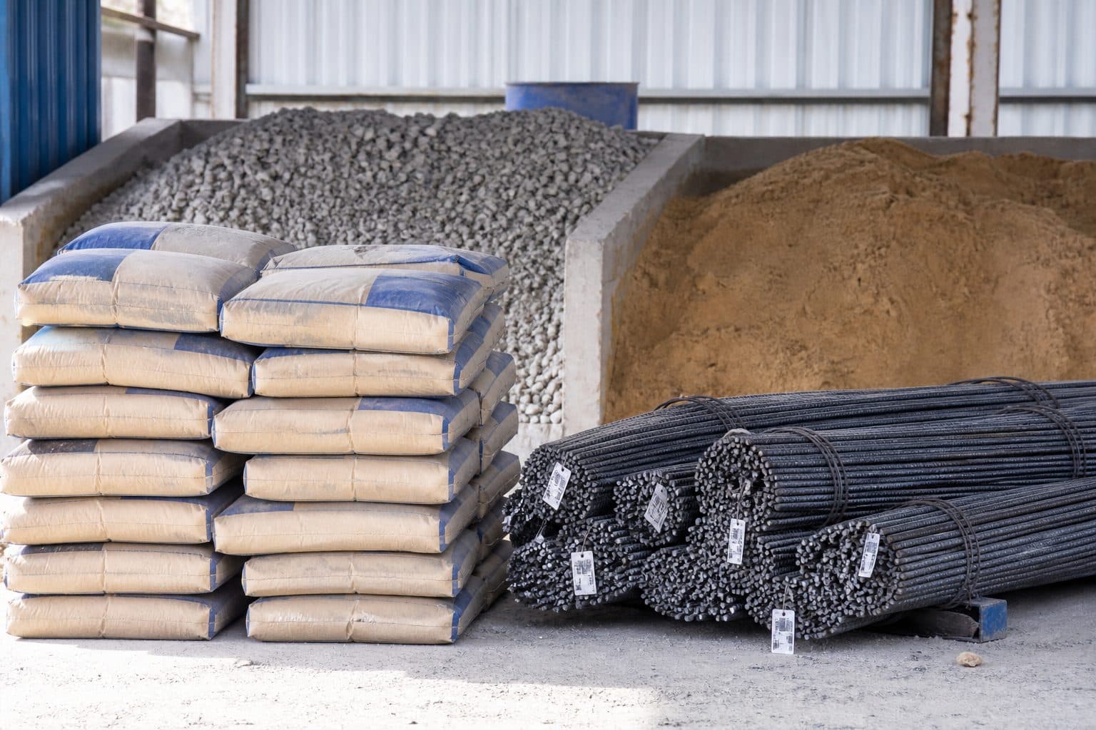 OPC cement bags and Fe 500D TMT steel staged for a Maharashtra bungalow build